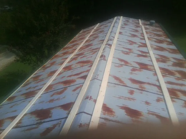 Rusted metal roof panels with new wood purlins before replacement — Storm Damage Roof Repair in Onslow by Roofing Brothers